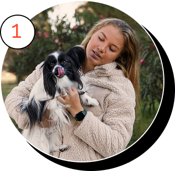 A lady holding her dog.